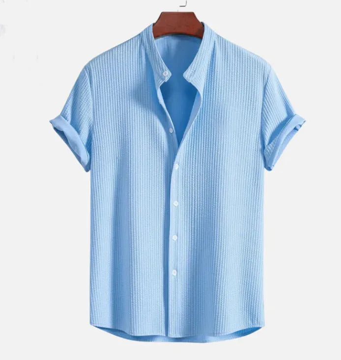 Man wearing a loose-fit short sleeve casual shirt in a solid colour, available in multiple sizes.
