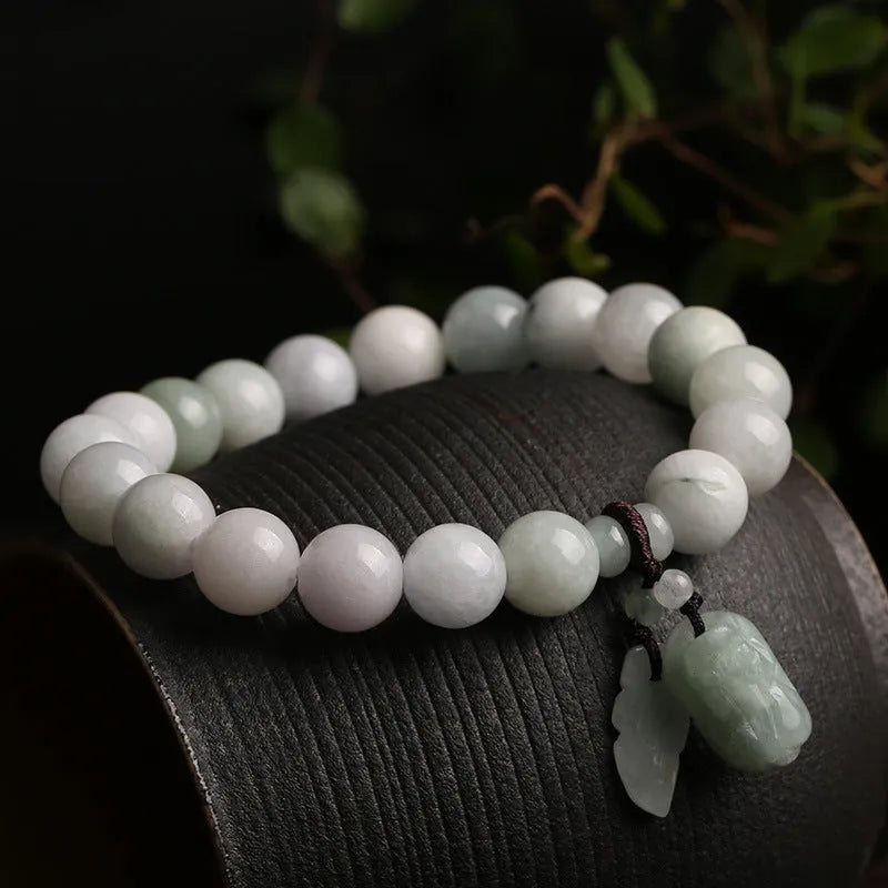 Natural jade Buddhist hanging bracelet showing geometric shape and symbolic charms