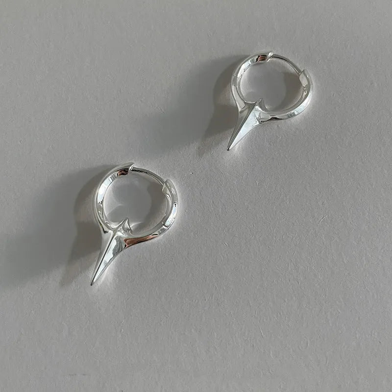 Gold electroplated copper star-shaped ear clips for women, showing geometric design.
