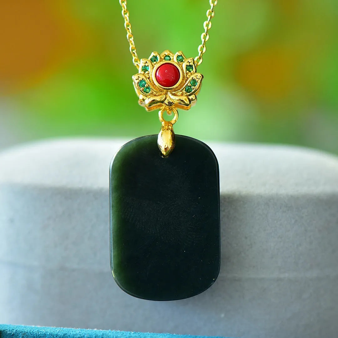 Close-up of a natural Hetian jade pendant with intricate copper inlay detail on a necklace chain.