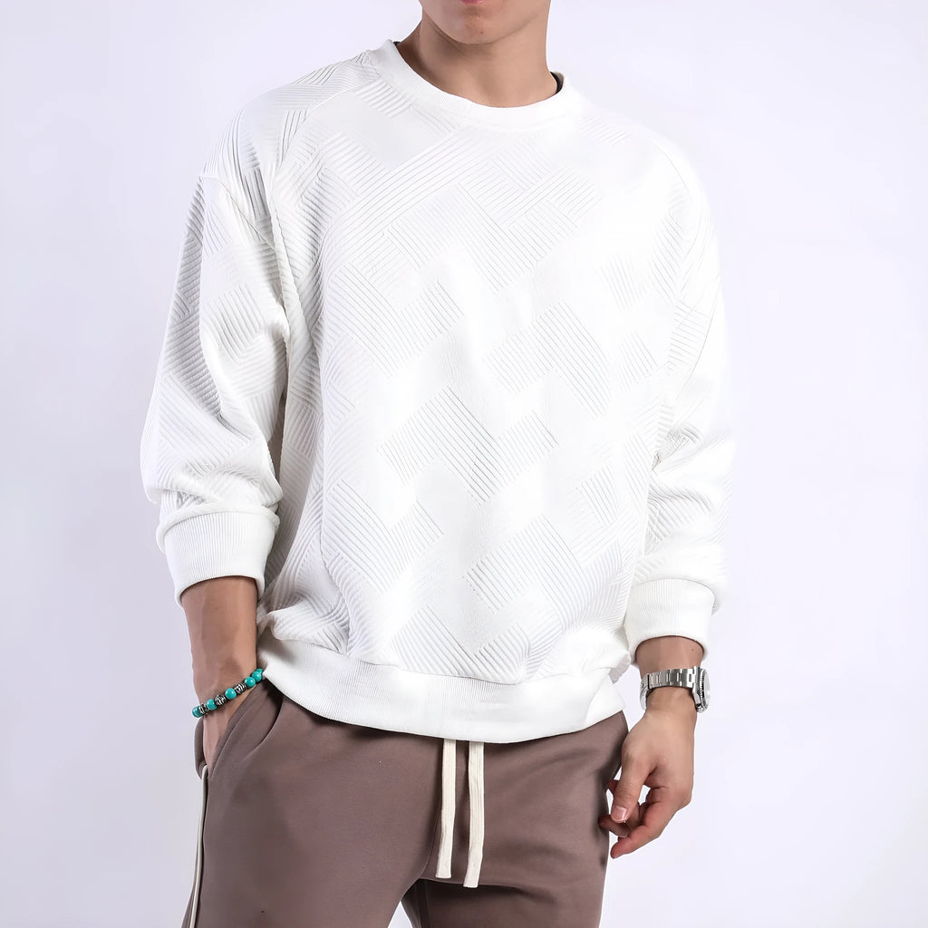 Men's loose fit long-sleeved twill jacquard sweater in a solid colour on a hanger