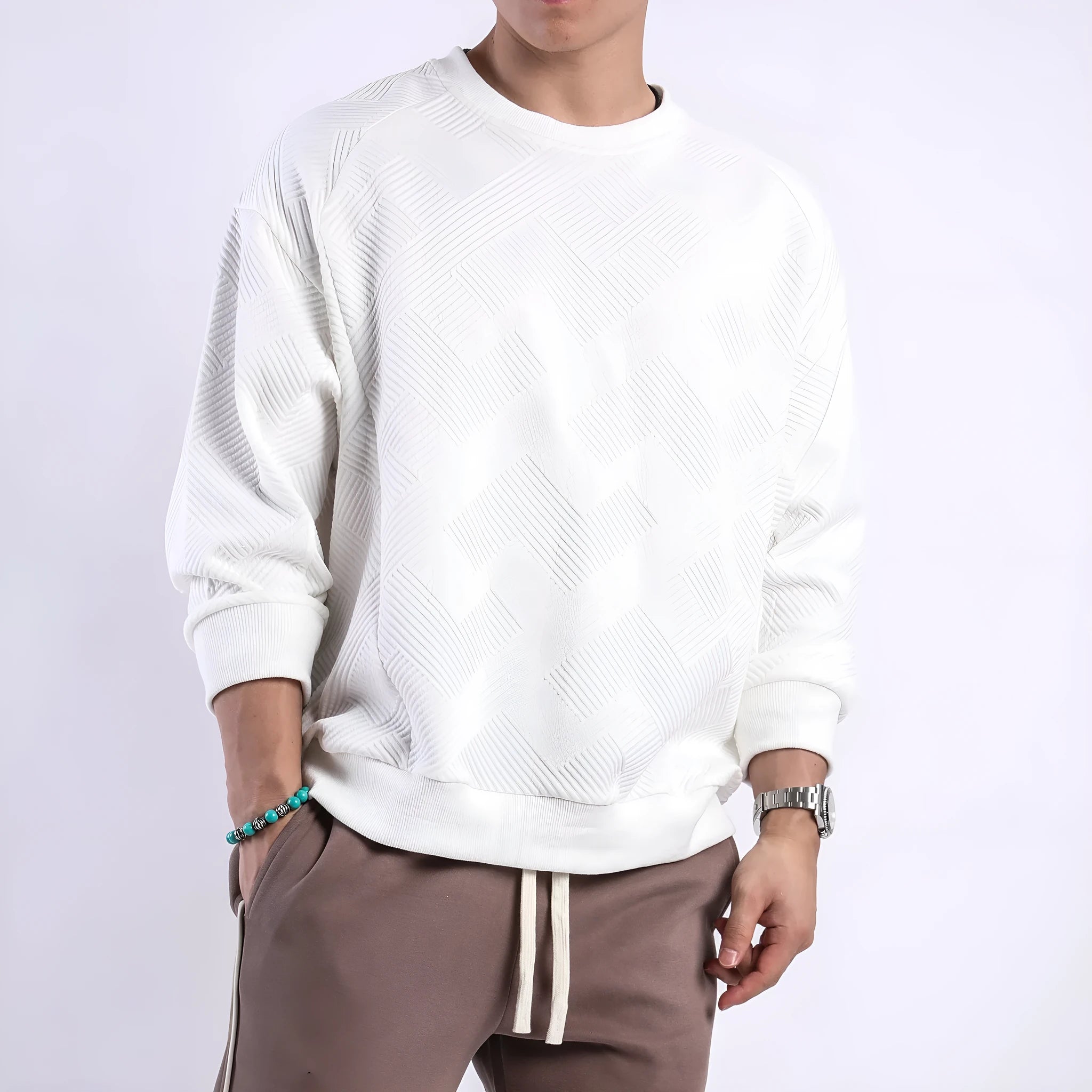 Men's loose fit long-sleeved twill jacquard sweater in a solid colour on a hanger