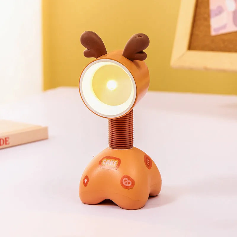 DIY cartoon animal small night lamp with magnetic base in assorted colours on a desk.