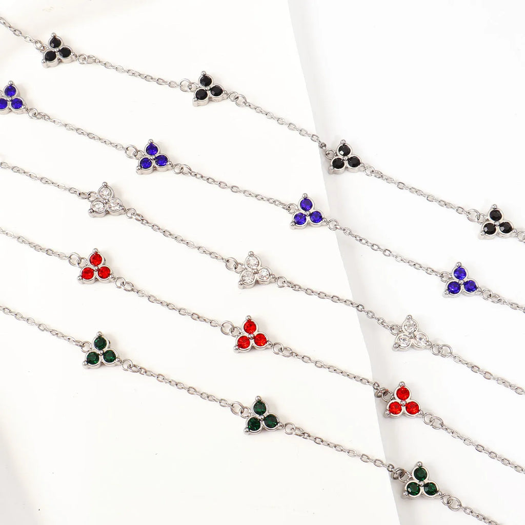 Women's stainless steel geometric bracelet with triangle details and a coloured stone setting.