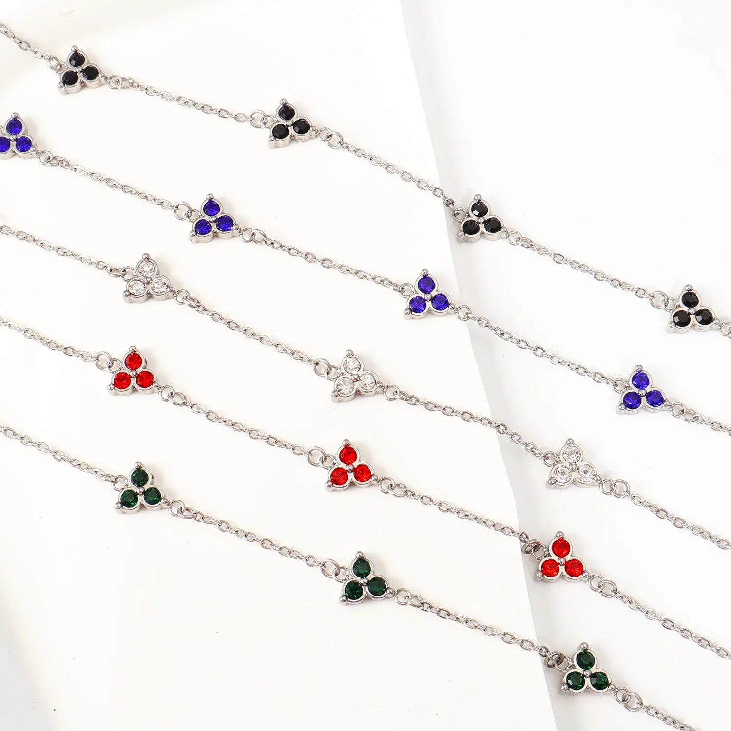 Women's stainless steel geometric bracelet with triangle details and a coloured stone setting.