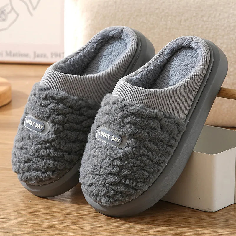 Men's grey thick-soled winter slippers with rabbit hair upper and textured sole.