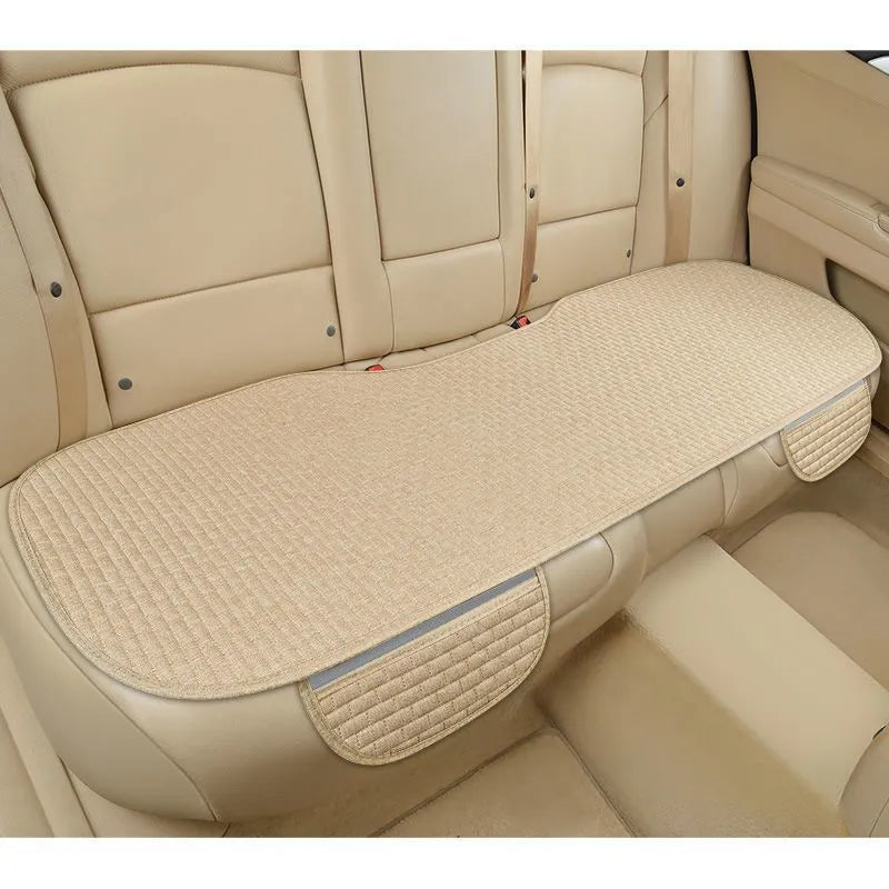 Linen car seat cushion in charm coffee colour, showing hemming detail, on a car seat.