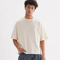 Man wearing a loose-fit apricot coloured pure cotton t-shirt, American style, short sleeves.