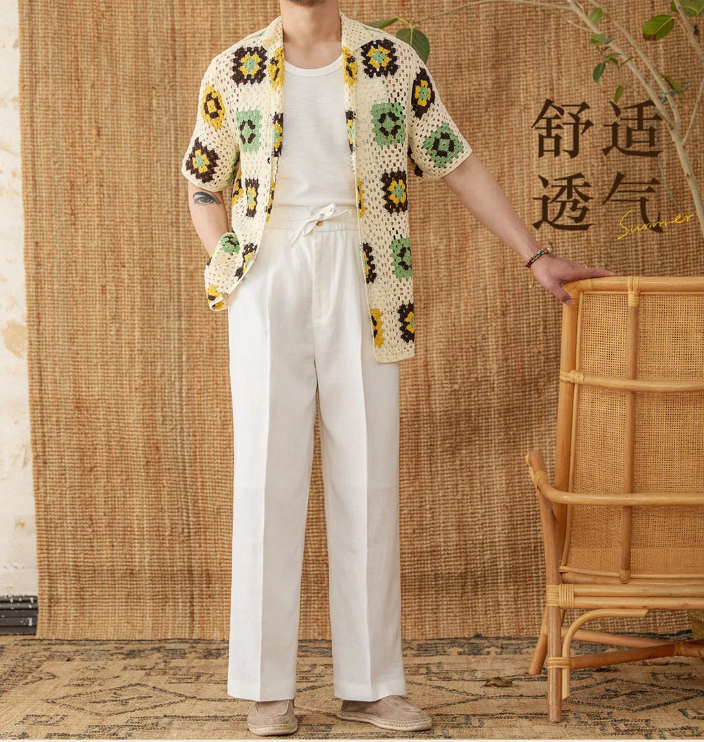 Navy blue linen high-waisted trousers with an elasticated waistband and straight-leg fit on a model.