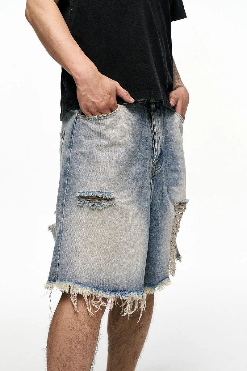 Light blue men's baggy denim shorts with a wide leg and retro washed finish on a mid waist.