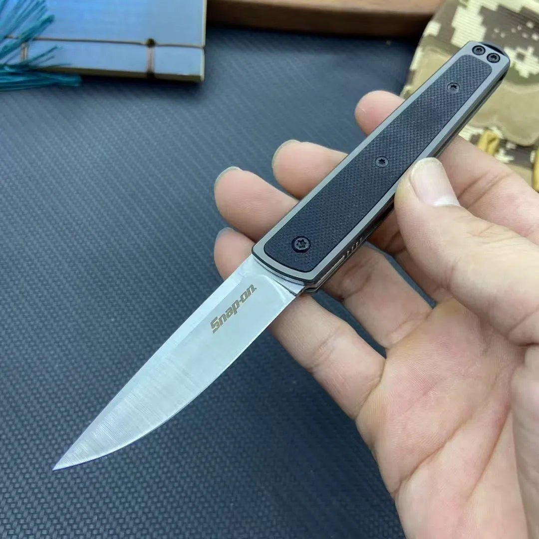 Closed and open views of a folding fruit knife with stainless steel blade in black, brown, or red handle options.
