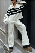 Women's black knitted two-piece set with polo collar top and straight-leg trousers.