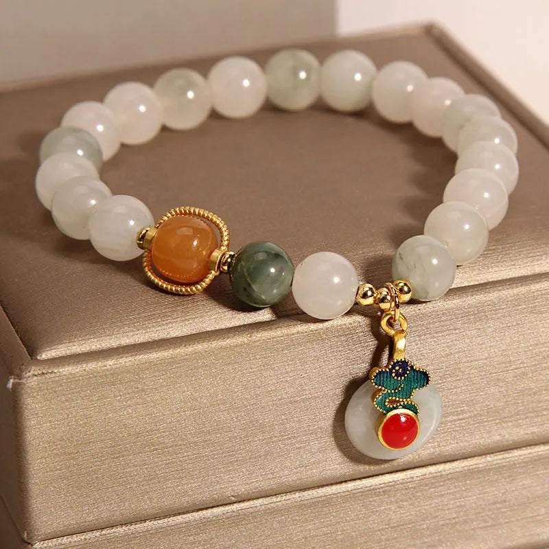 Women's jade crystal bracelet with ice jade colour, pearl accents, and peace jade buckle