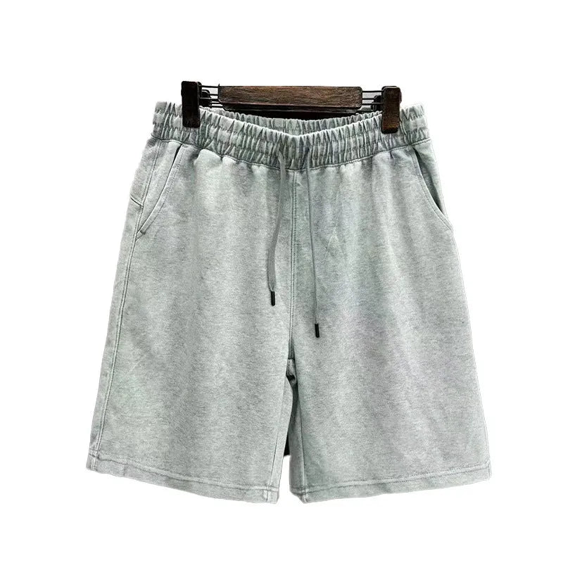 Men's distressed cotton casual shorts in loose straight fit showing fifth length measurement