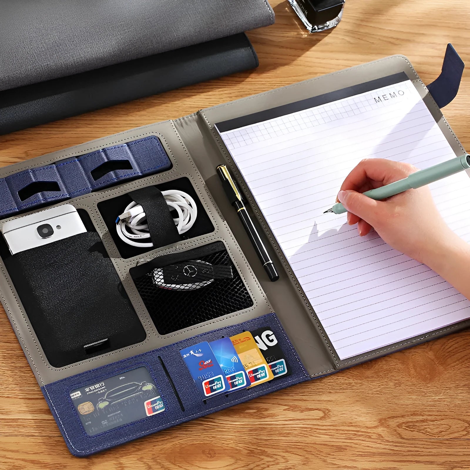 Leather A4 business folder in black, open to show interior with optional pen and notepad.
