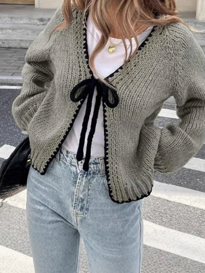 Gray lace-up front cardigan sweater with white crochet flower details and loose long sleeves.