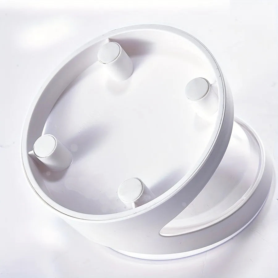 Clear plastic elevated cat food bowl with tilt design on white surface