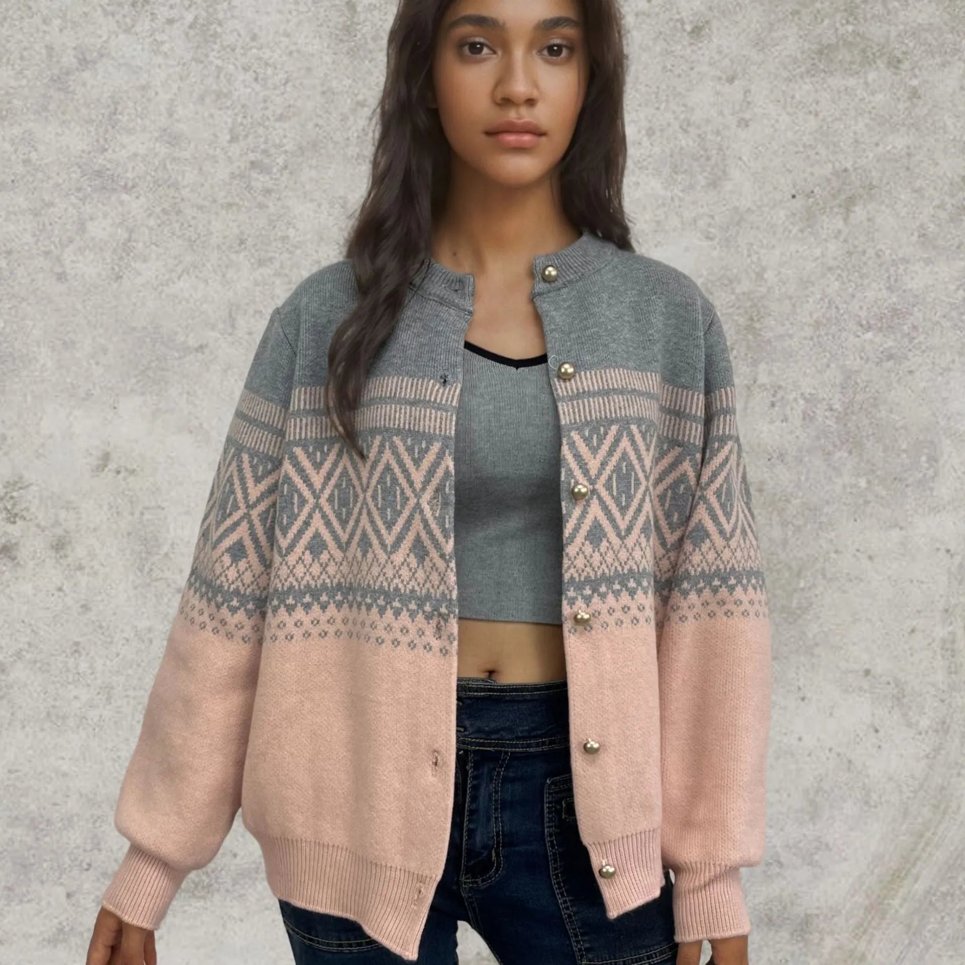 Woman wearing a grey diamond knit cardigan with contrast colour panels, long sleeves.