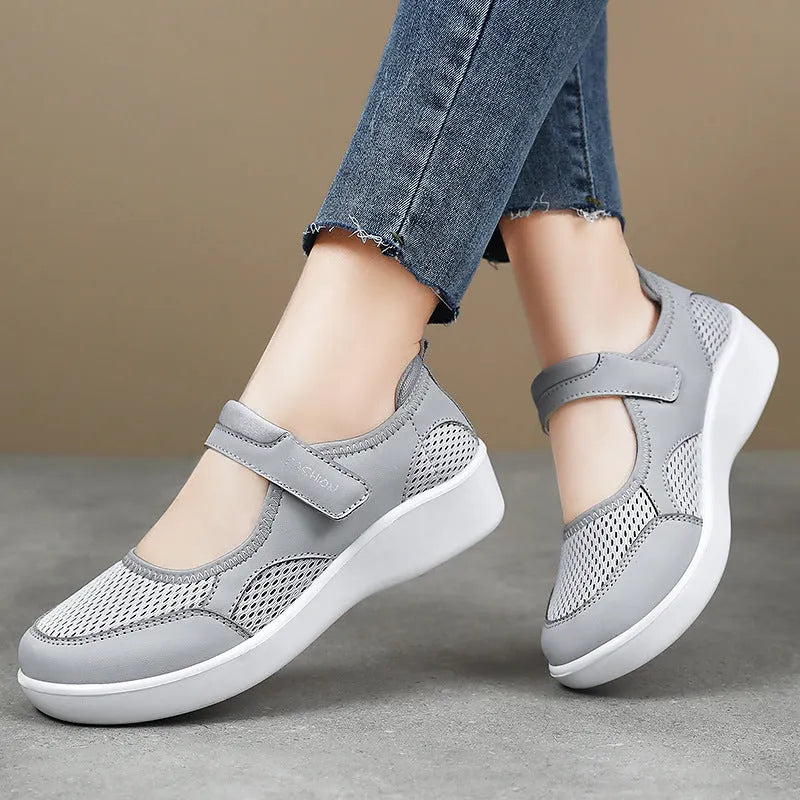 Women's low-top casual shoe in grey mesh with Velcro strap and flat polyurethane sole.