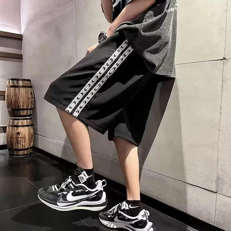 Men's black baggy track pants with loose fit and elasticated waist for casual sports wear