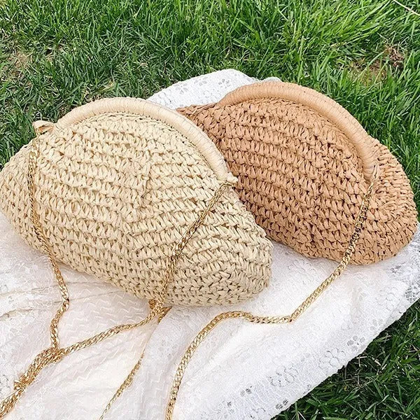 Women's straw beach bag with chain trim in khaki colour, showing shell shape and shoulder strap