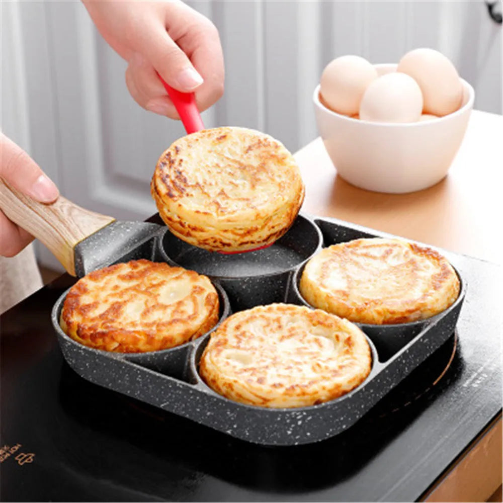 Non-stick four-hole frying pan with medical stone coating on a gas hob cooking eggs and pancakes