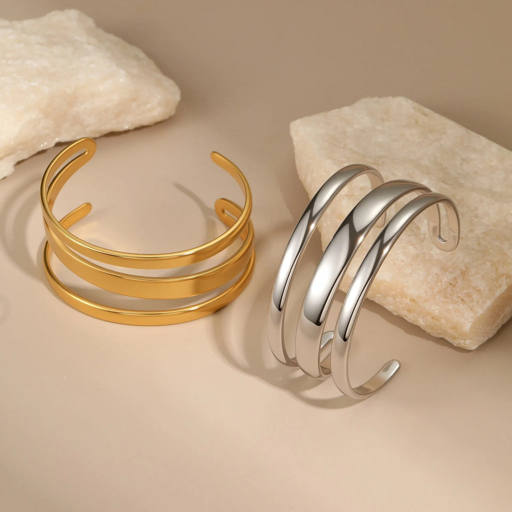 Geometric stainless steel women's bracelet with a simple opening, shown in gold and steel colour options.