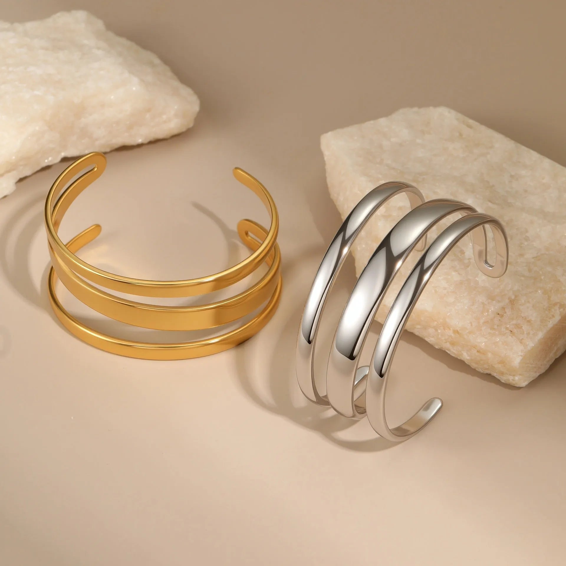 Geometric stainless steel women's bracelet with a simple opening, shown in gold and steel colour options.