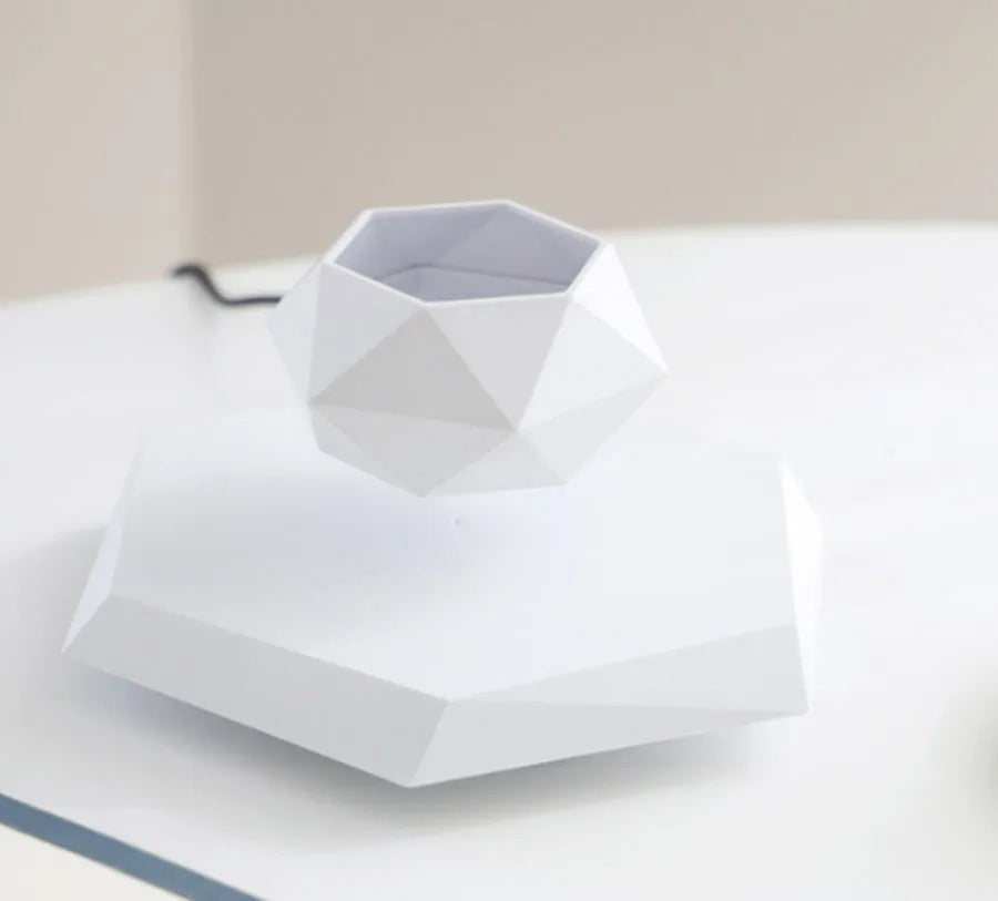 Floating magnetic levitating flower pot in wood grain finish with micro plant suspended 15mm above hexagonal base