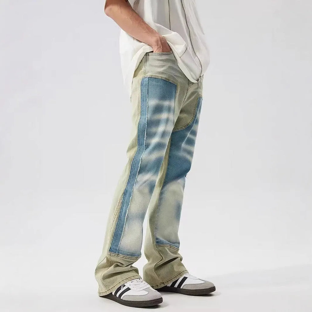 Yellow and blue retro patchwork distressed jeans with splash-ink design details on mid-waist denim trousers