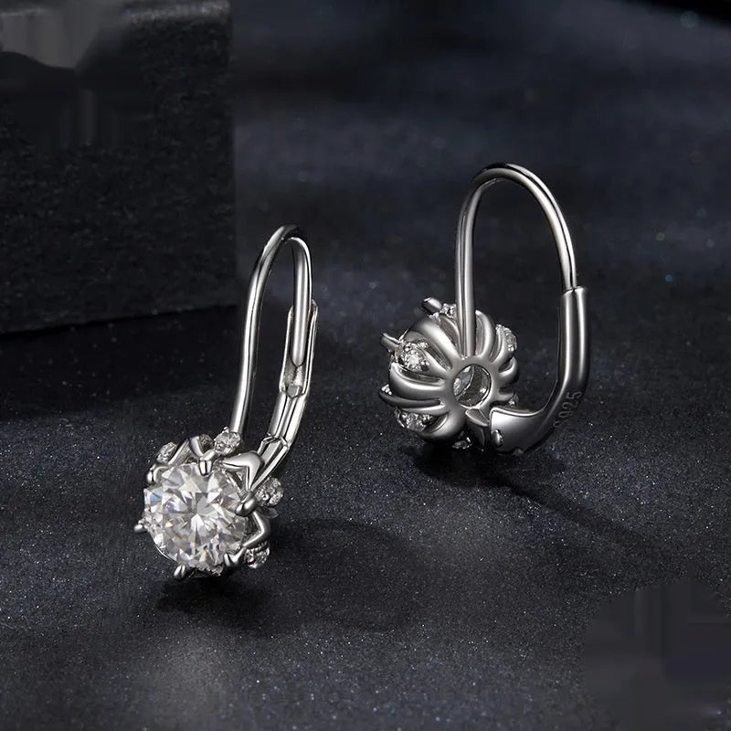 White gold plated sterling silver flower ear clip with moissanite centrepiece.
