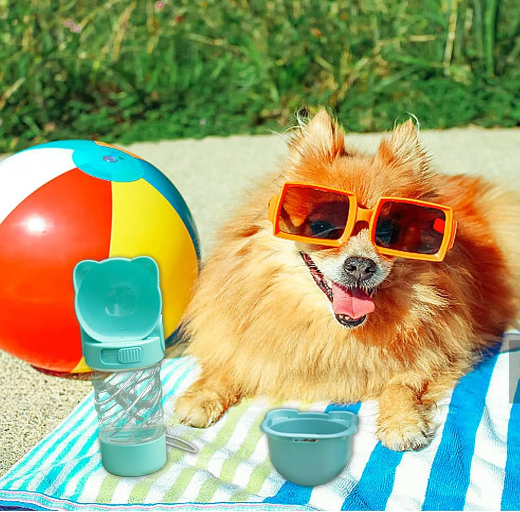 Green 3-in-1 portable pet water bottle with food container and waste bag dispenser on a strap.