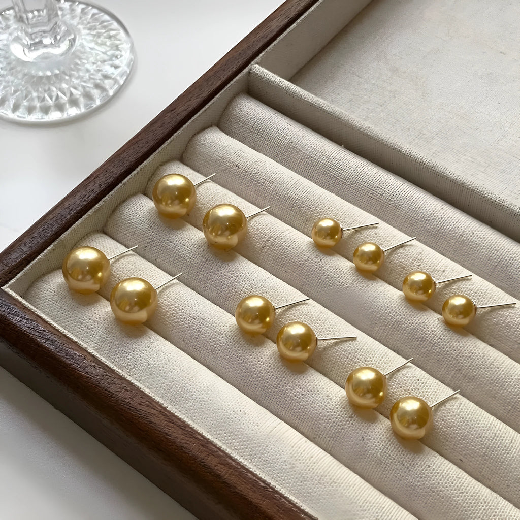 Geometric pearl stud earrings with retro styling in silver with eight-point star details