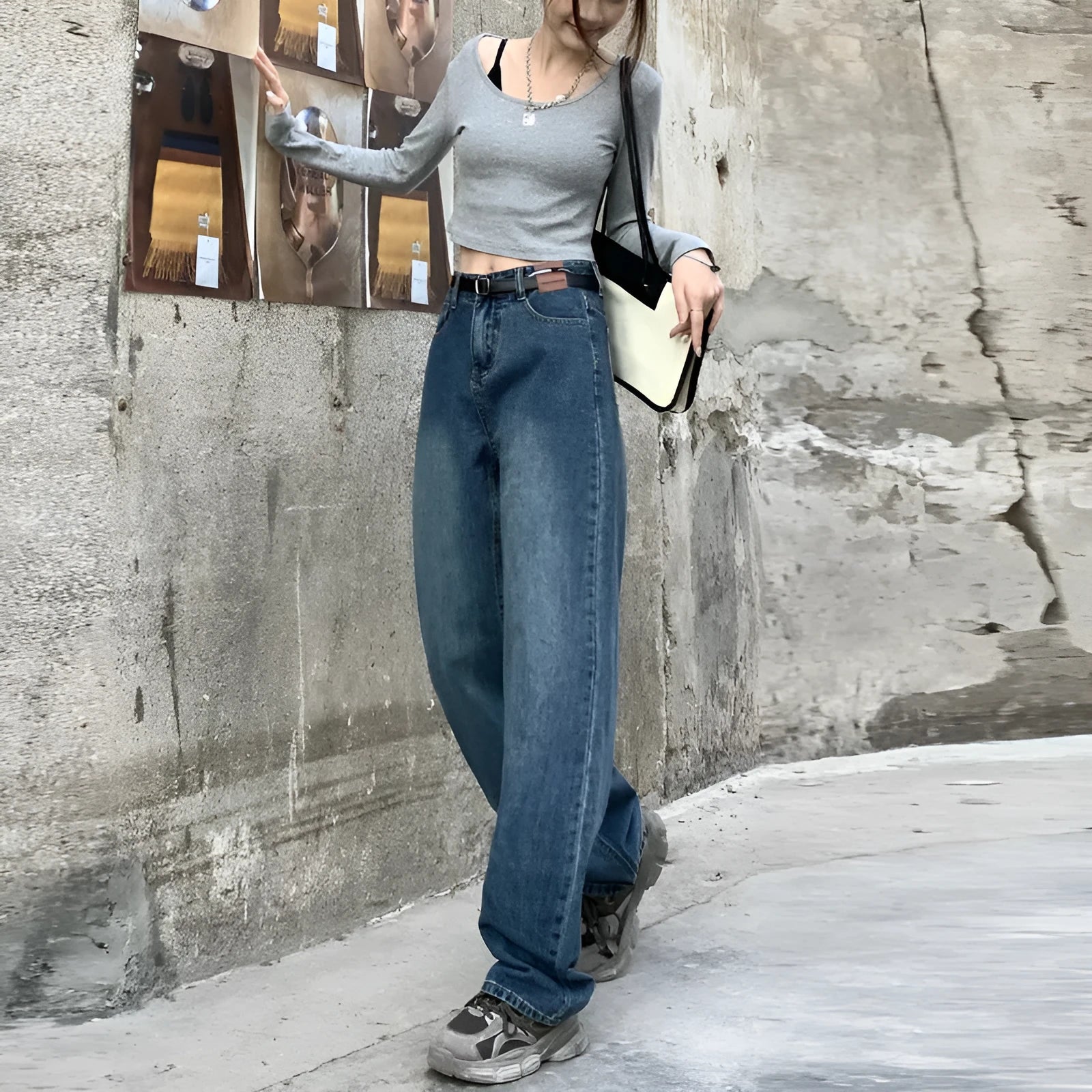 Women's retro blue high-waist straight-leg jeans on a neutral background.