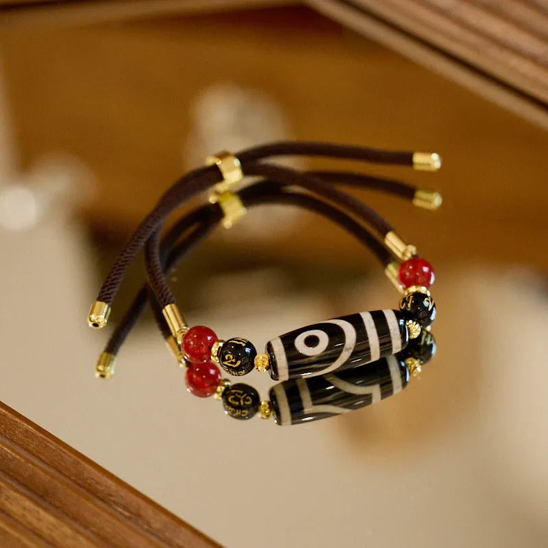 8mm agate Dzi bead bracelet with geometric shape and Tibetan-style beaded strap.