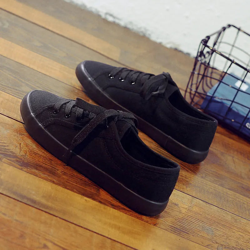 All black Korean style canvas flat work shoes for women with front lace-up and rubber sole