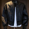Black extended-length men's PU leather jacket with a litchi texture on a hanger.