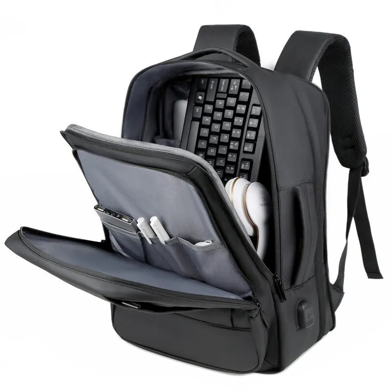Black Oxford cloth waterproof backpack with curved shoulder strap, shown with a laptop compartment open.