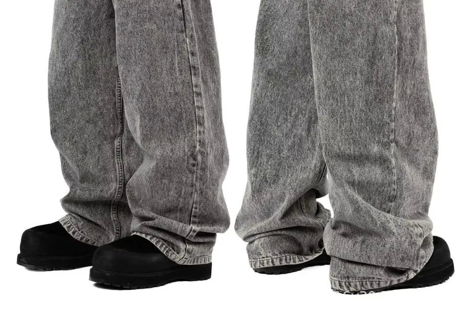 Grey loose-fit straight-leg cotton denim trousers on a hanger.