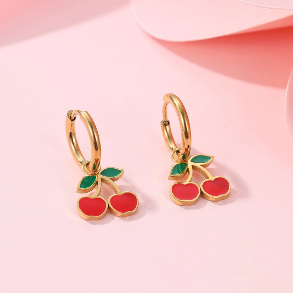 Four-piece stainless steel cherry jewellery set with gold plating: necklace, bracelet, earrings, and ring.