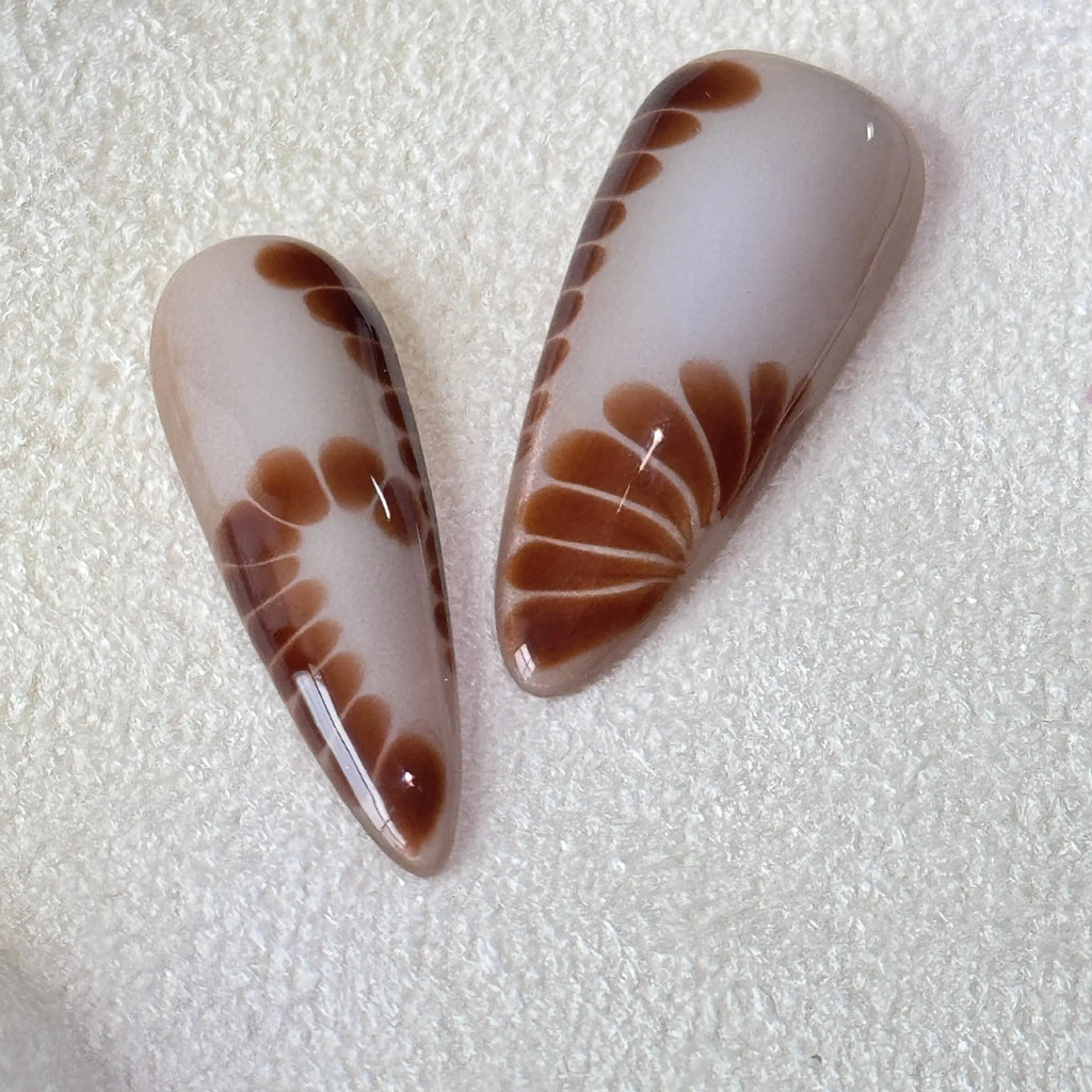 Leopard print press-on nails with cross and flower patterns in four sizes
