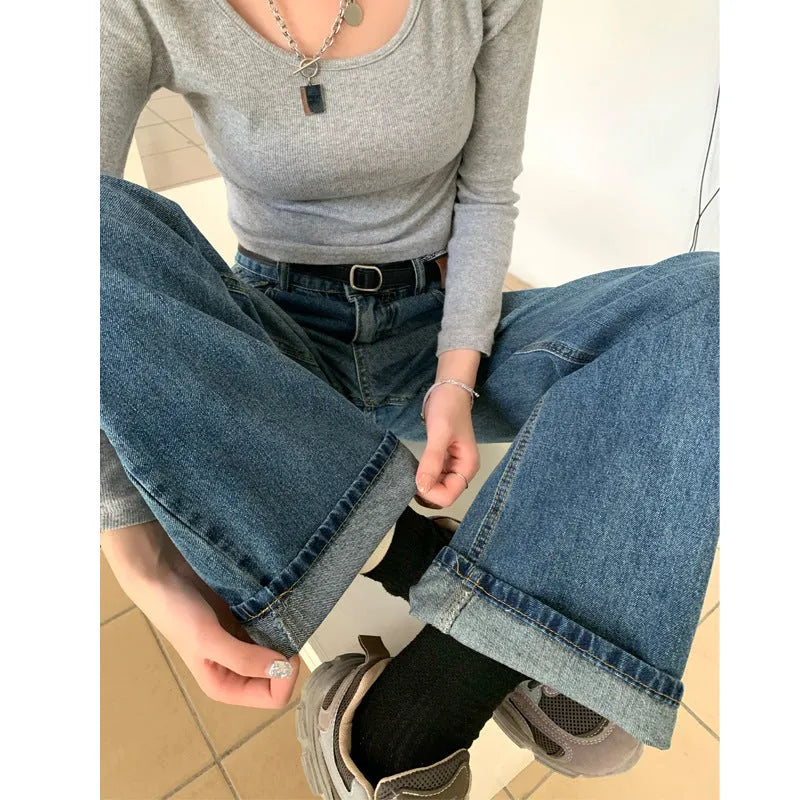 Women's retro blue high-waist straight-leg jeans on a neutral background.