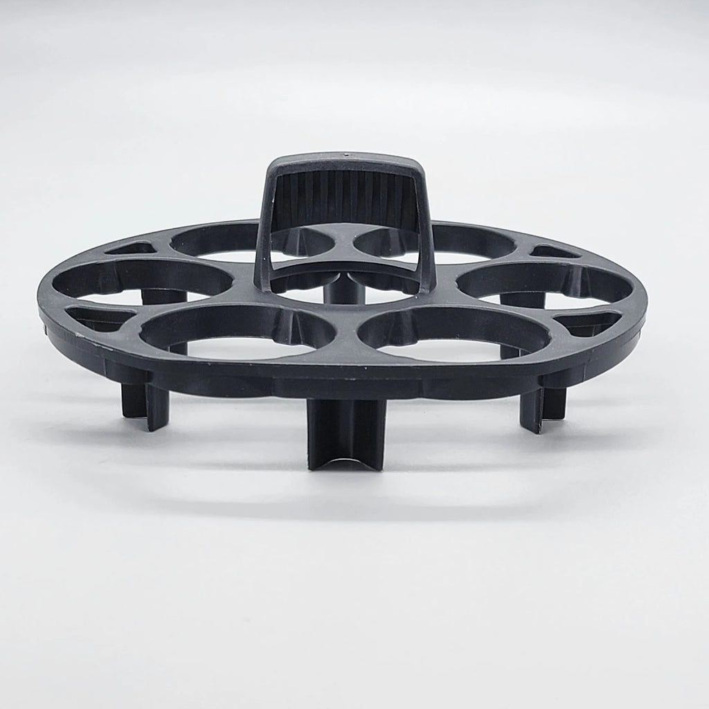 Black plastic egg holder cooking basket rack on a kitchen counter.