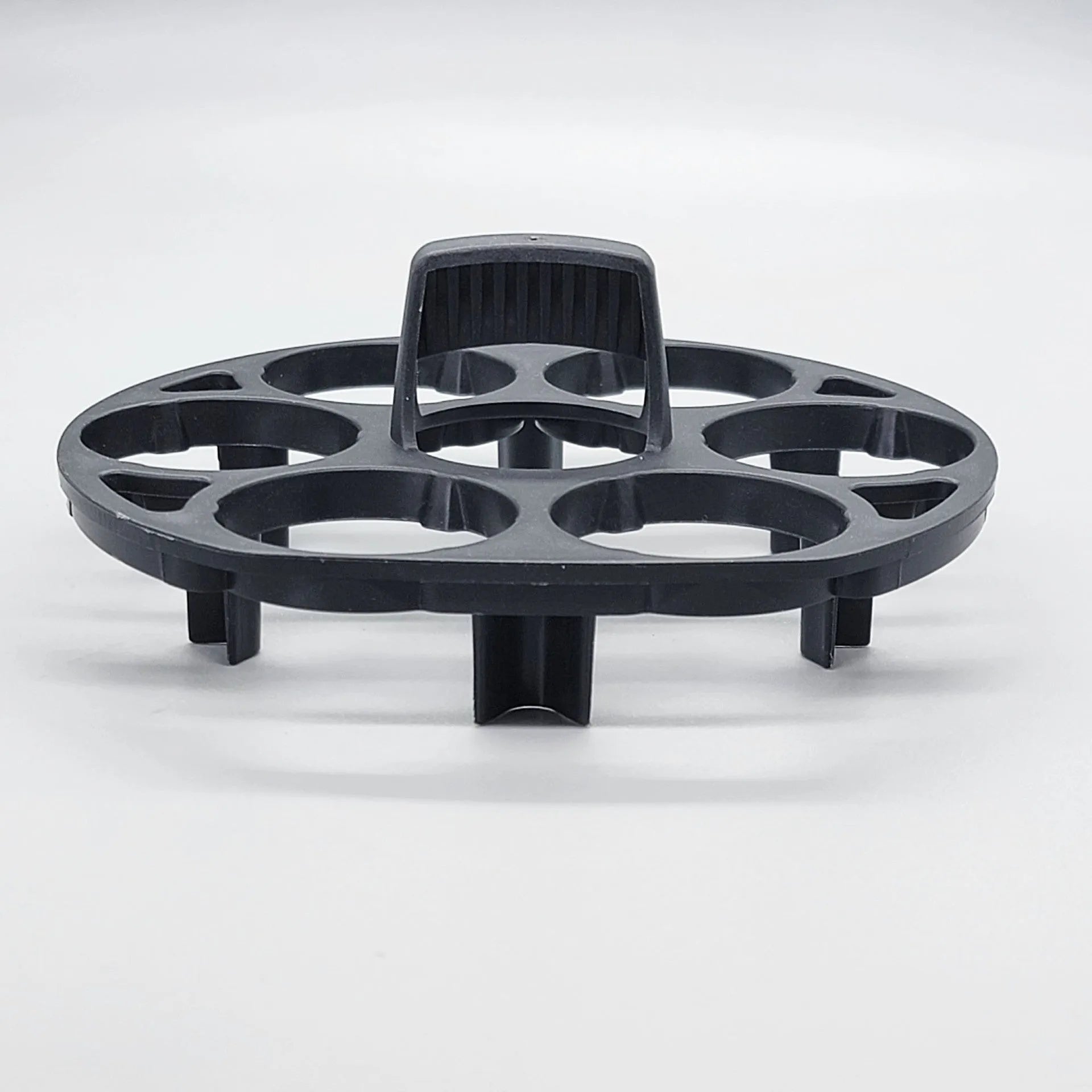 Black plastic egg holder cooking basket rack on a kitchen counter.