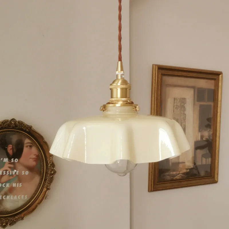 Medieval French style brass chandelier with flower bud details and glass lamp body
