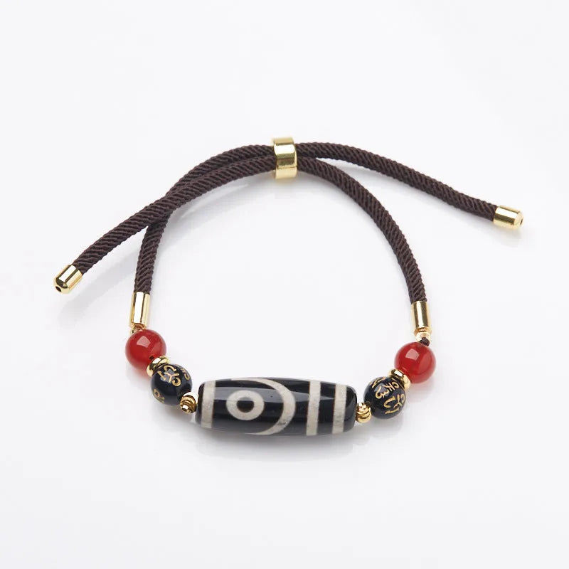 8mm agate Dzi bead bracelet with geometric shape and Tibetan-style beaded strap.