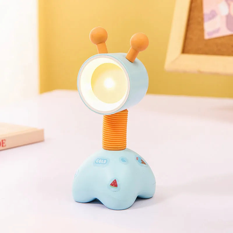 DIY cartoon animal small night lamp with magnetic base in assorted colours on a desk.