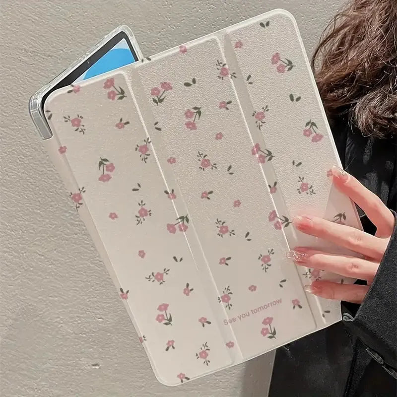 Clear iPad case with floral cartoon pattern, shown folded into a stand position.