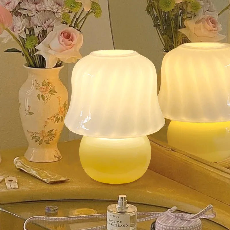 Handmade glazed glass mushroom lamp in cream yellow with push button switch on bedside table