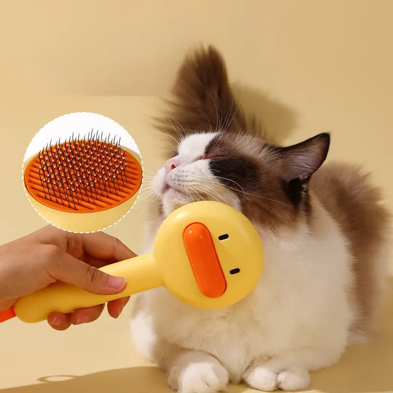 Small yellow duck-shaped pet grooming comb with needle teeth for cats and dogs